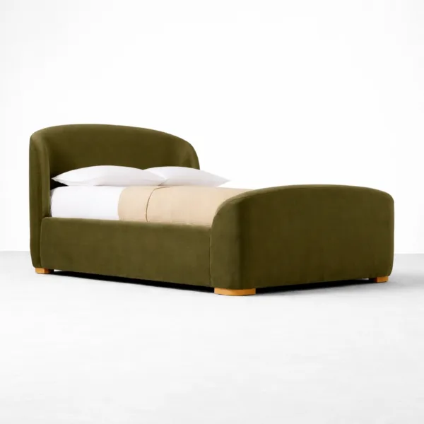 Olive green upholstered bed with curved headboard and teakwood base by INTERIORZE