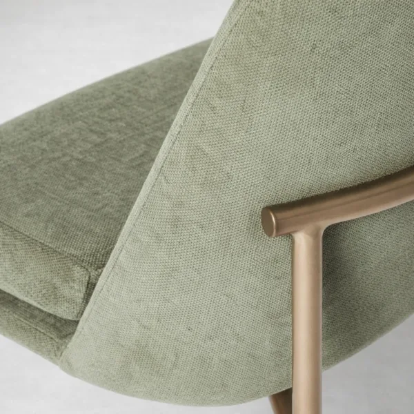 Sage green upholstery texture and gold metal frame detail on INTERIORZE Aurora dining chair