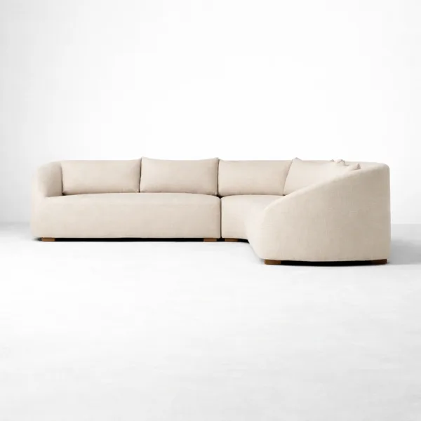 Curved ivory linen sectional sofa side angle showing rounded arms by INTERIORZE