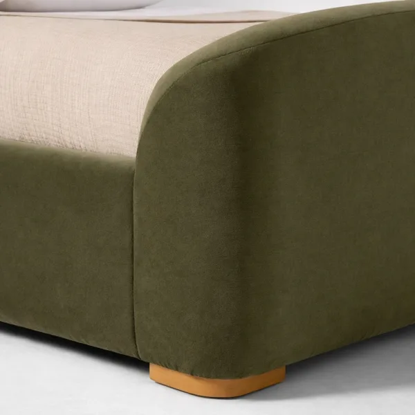 Teakwood base and leg detail of olive green upholstered bed by INTERIORZE
