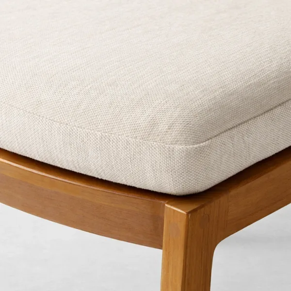 Close up of beige upholstered seat on INTERIORZE teakwood dining chair