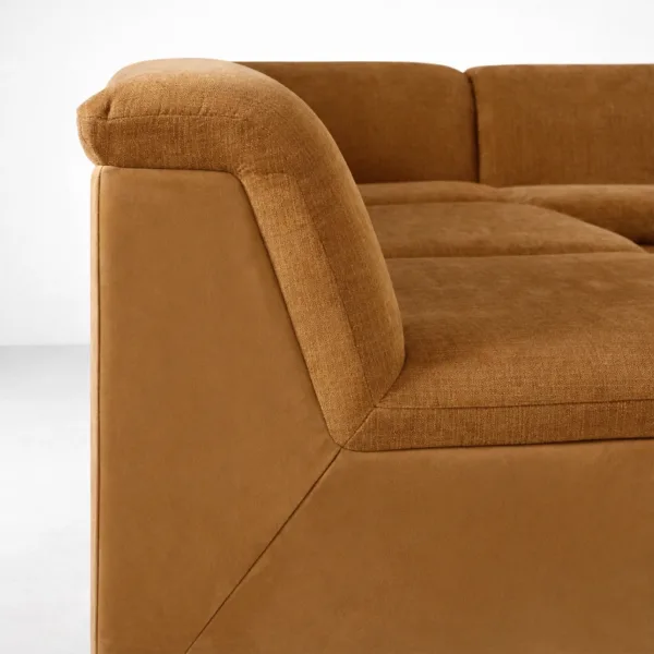 Tan modular L shaped sectional sofa armrest close up INTERIORZE