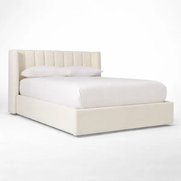 Ivory upholstered bed with teakwood frame showing padded channel headboard and wings