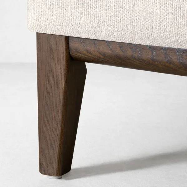 Teakwood leg and base detail of ivory L-shape sectional sofa