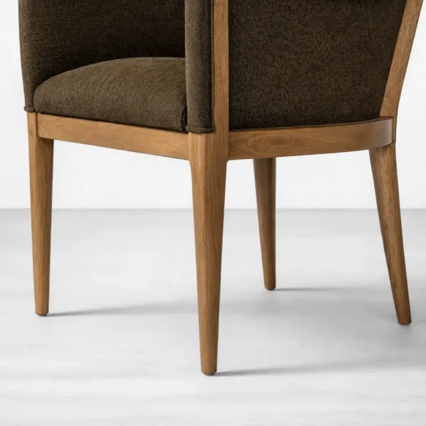 Close-up of teakwood finish and dark fabric upholstery on dining chair