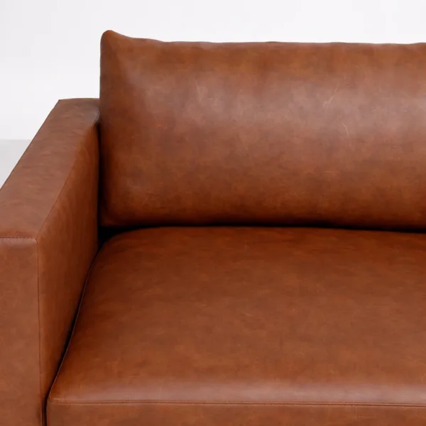 Brown leather L shape sofa chaise detail with wide arm by INTERIORZE
