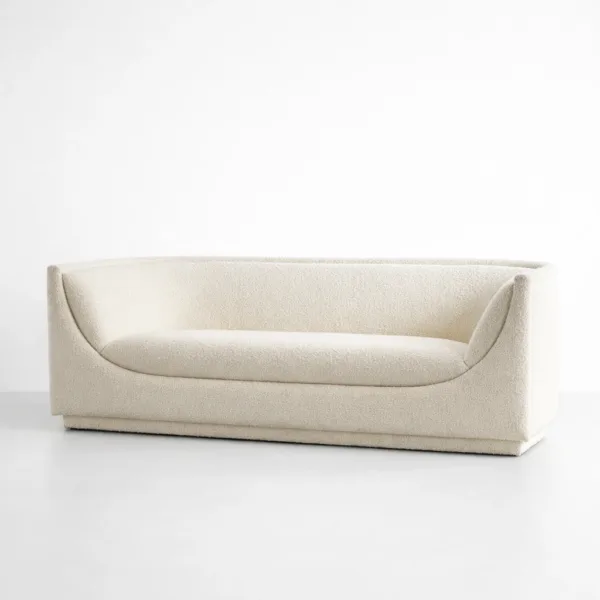 Angled view of INTERIORZE Arcline ivory boucle 2 seater sofa showing curved back, sculpted arms, and lounge-ready seat