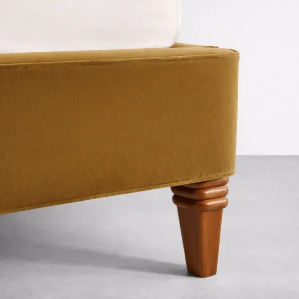 Teakwood legs detail of mustard velvet upholstered bed INTERIORZE Aurelia