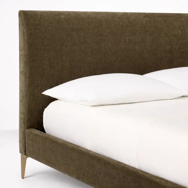 Padded headboard detail on olive upholstered bed with soft upholstery
