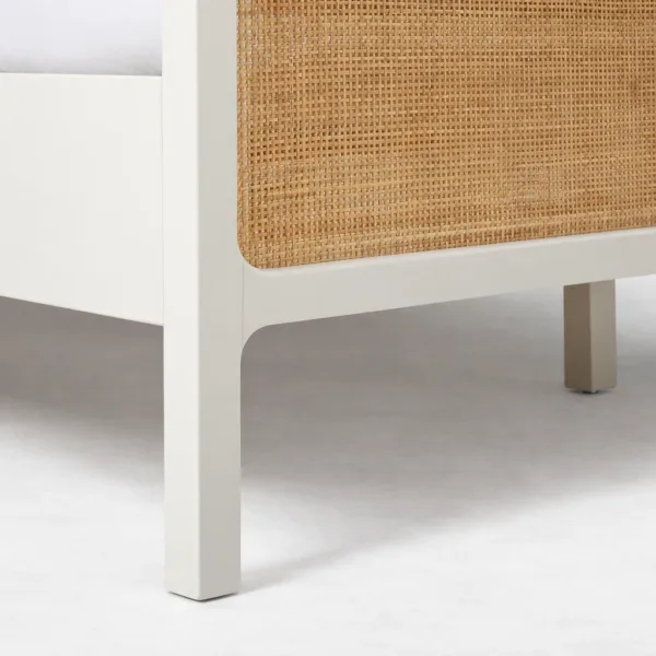 Cane panel bed close-up showing ivory leg design and cane footboard panel texture