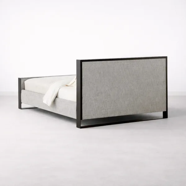 Rear angled view of INTERIORZE Aster teakwood upholstered bed with metal legs in grey fabric