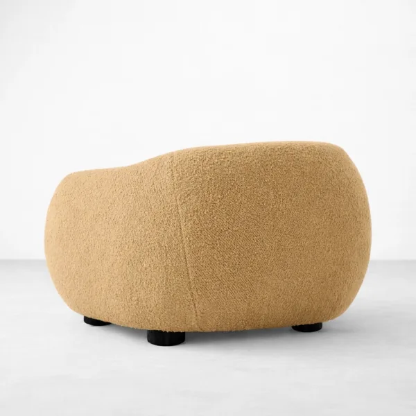 Beige boucle lounge chair with teakwood legs rear angle view, INTERIORZE SANDDUNE.