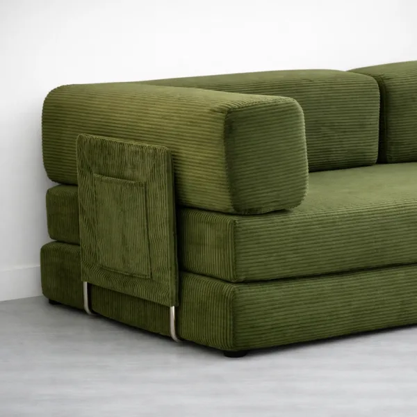 Close-up of olive corduroy ribbed fabric and armrest detail on sofa cum bed INTERIORZE