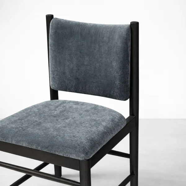 Slate grey upholstery fabric texture and teakwood frame detail on INTERIORZE Noir dining chair