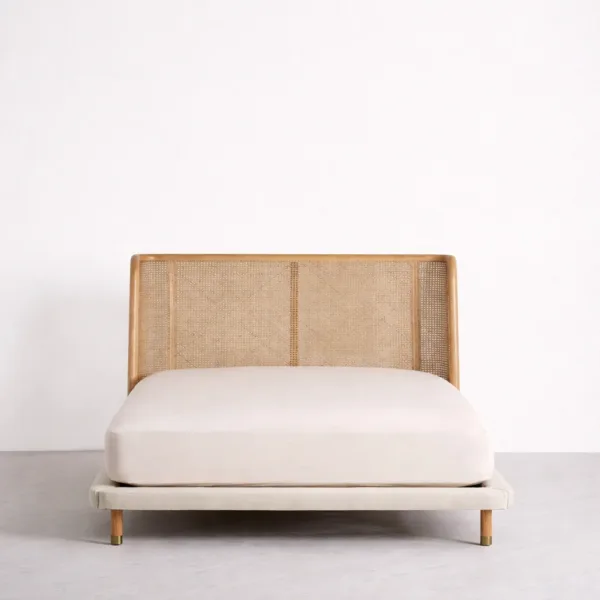 Teakwood cane bed front view with cane headboard and upholstered base
