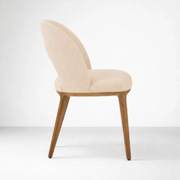 Upholstered teakwood dining chair side view cream upholstery walnut polish legs