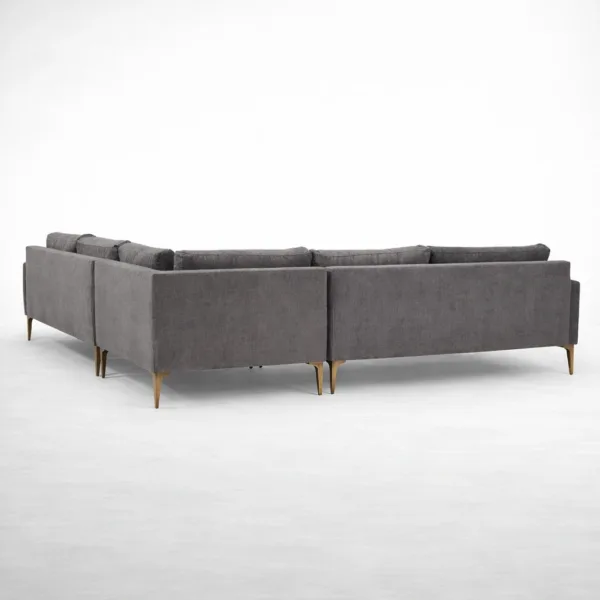 Rear view of charcoal grey L shape sectional sofa with brass legs