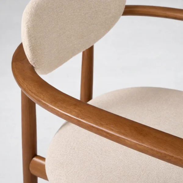 Ivory boucle upholstery texture and teakwood armrest detail on INTERIORZE Halo chair