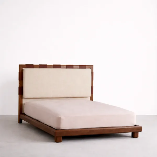 Teakwood upholstered bed with leather strap headboard detail angled view