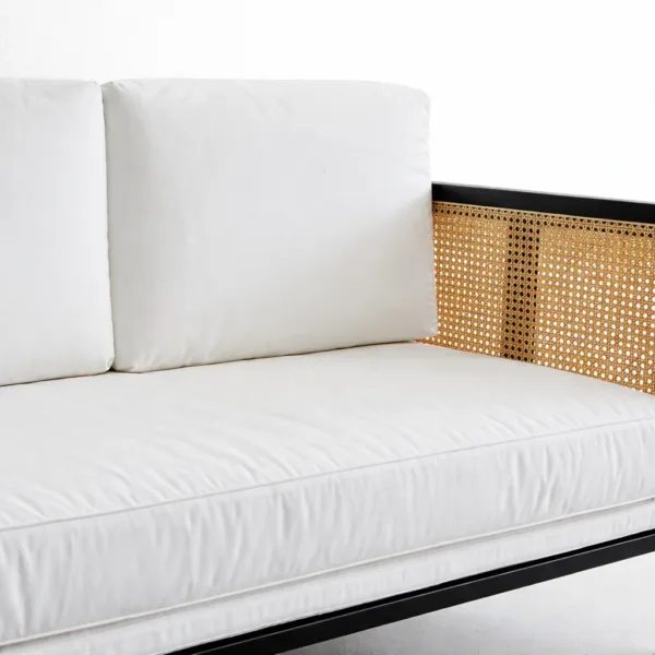 Ivory cushion and cane arm panel detail on teak cane 2 seater sofa by INTERIORZE