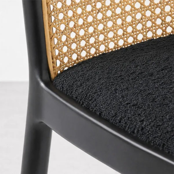 Close up of cane weaving and black upholstered seat on INTERIORZE dining chair