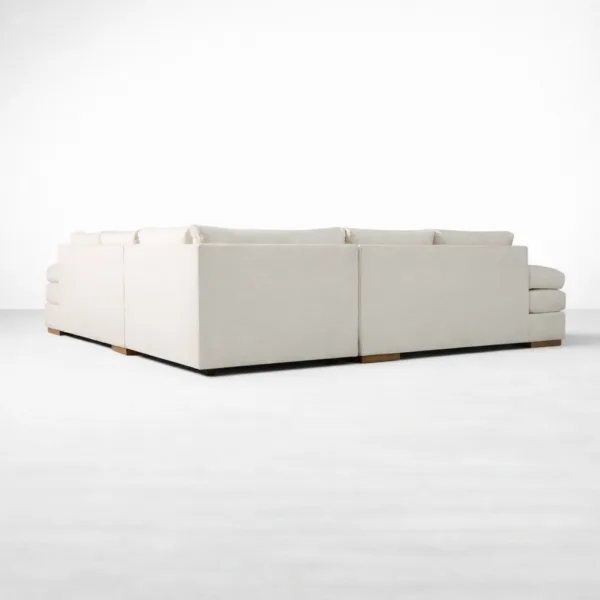 Rear view of ivory linen L shape sectional sofa with wooden base