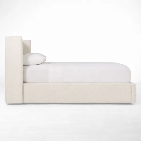 Side profile of ivory upholstered bed with teakwood frame in queen size