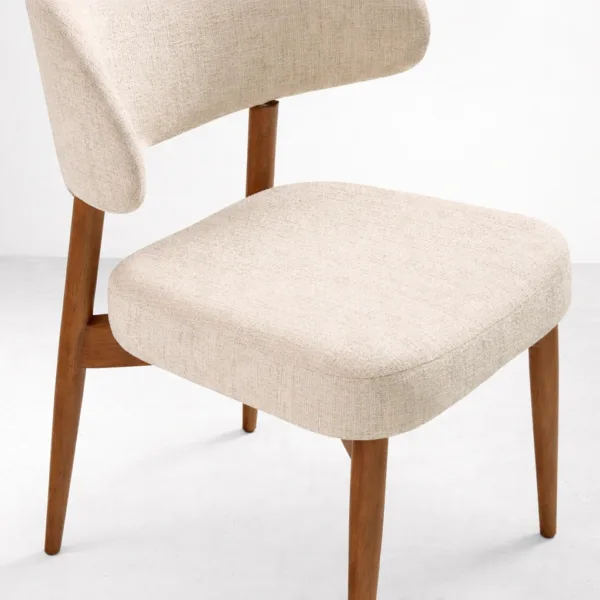 Close up beige upholstered dining chair seat fabric texture and cushioning