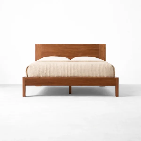 Solid teakwood bed with curved panel headboard in warm teak polish by INTERIORZE