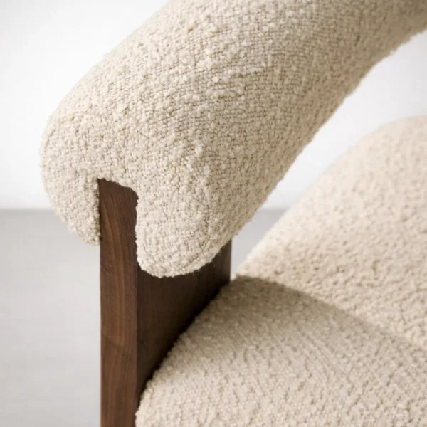 Close up of boucle fabric and teakwood frame on INTERIORZE dining chair