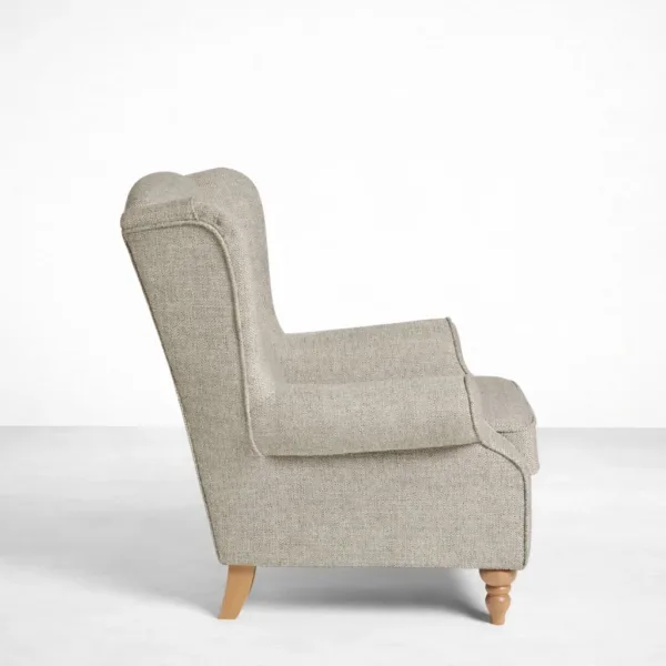 Beige wingback armchair with teakwood legs side view showing high back and rolled arms, INTERIORZE HERITAGEWING.