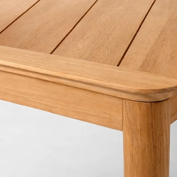 Close-up of teakwood tabletop and corner detailing on INTERIORZE Aurel dining table