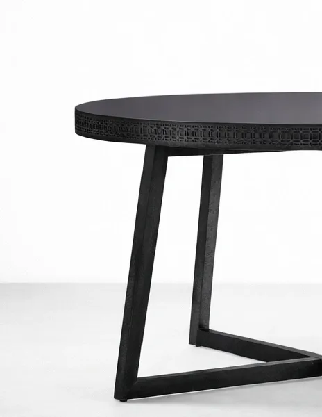 Angled view of INTERIORZE Nero Crest round dining table