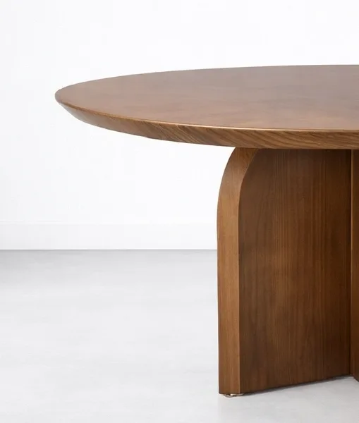 Side detail of INTERIORZE Elara round solid wood dining table with curved base