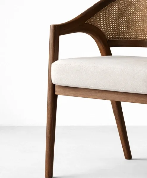 Close-up of cane backrest and off white upholstered seat on teakwood chair
