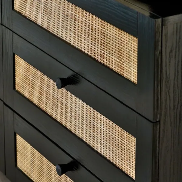 close-up of cane drawer detail on black teak wood chest of drawers