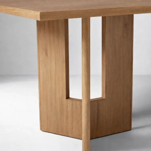 Close-up of sculptural teakwood pedestal base on INTERIORZE Varello dining table