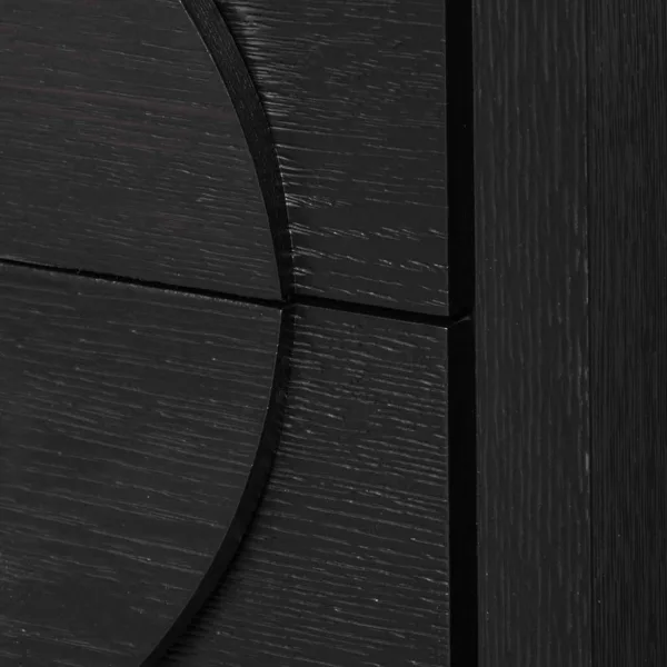 close up of geometric circular detail on black teakwood bedside table