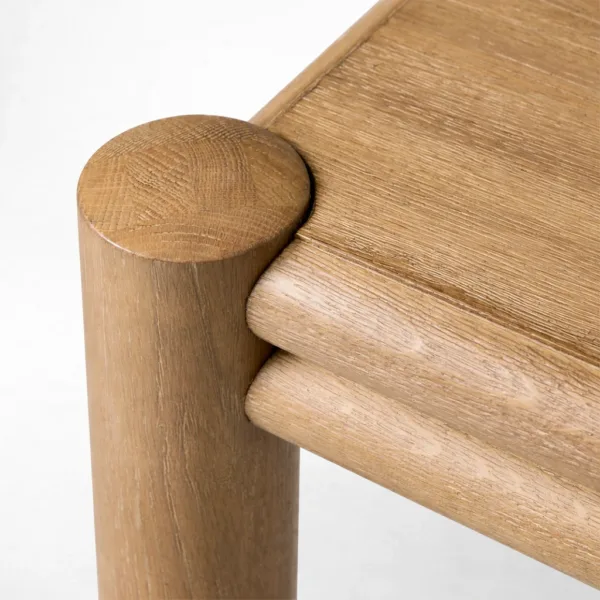 Close-up of teakwood table corner and rounded leg on INTERIORZE Norvik dining table
