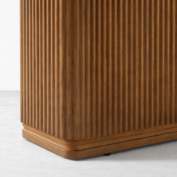 Close-up of fluted teakwood pedestal base of INTERIORZE Verona dining table