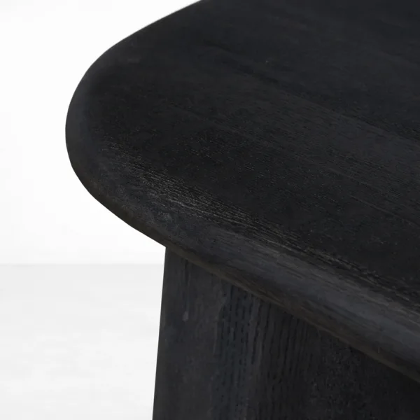 Close-up of rounded tabletop edge and dark wood grain on INTERIORZE Noir Arc dining table