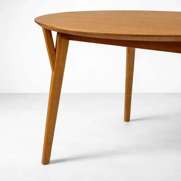 Close-up of angled teakwood leg on INTERIORZE Alvyn oval dining tabl