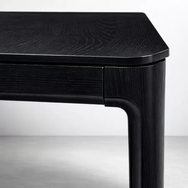 Close-up of tapered leg and smooth frame joint on INTERIORZE Kaelix black dining table