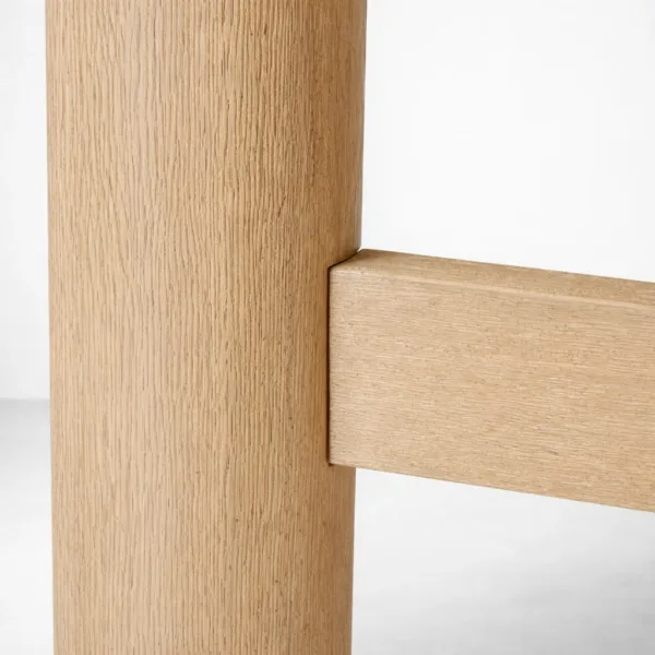 Close-up of cylindrical leg and cross support on INTERIORZE Orvyn teakwood dining table