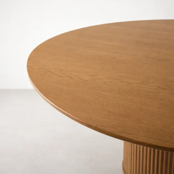 Close-up of round teakwood tabletop edge on INTERIORZE Elvoro dining table