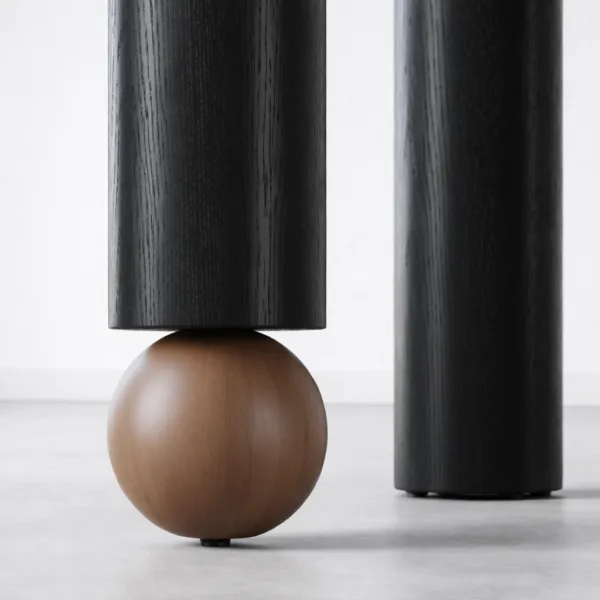 Close-up of contrast wood sphere accent on INTERIORZE Noir Axis solid wood dining table