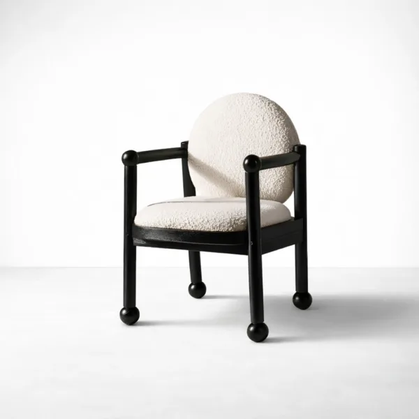 Teakwood bouclé arm chair in cream upholstery with black polished frame and round backrest