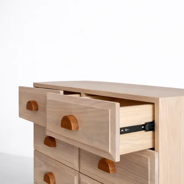 close up detail of woven cane drawer front in ash wood chest of drawers
