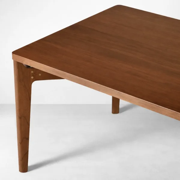Close-up of rectangular teakwood tabletop corner on INTERIORZE Cavero dining table