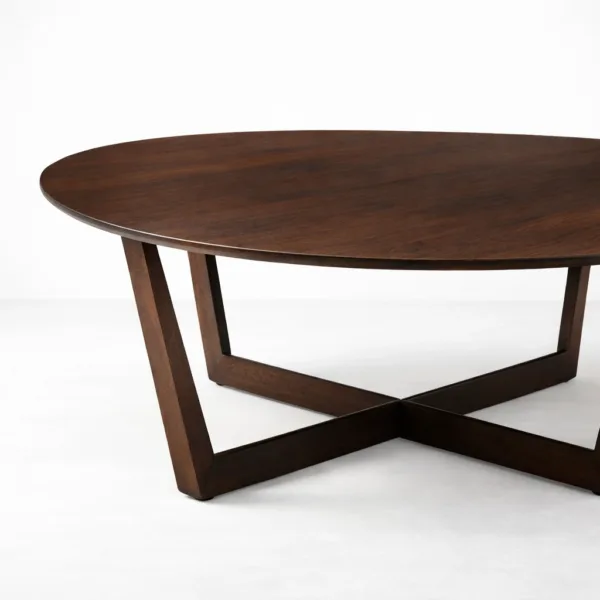 INTERIORZE teakwood oval center table with sculptural cross base in dark walnut finish